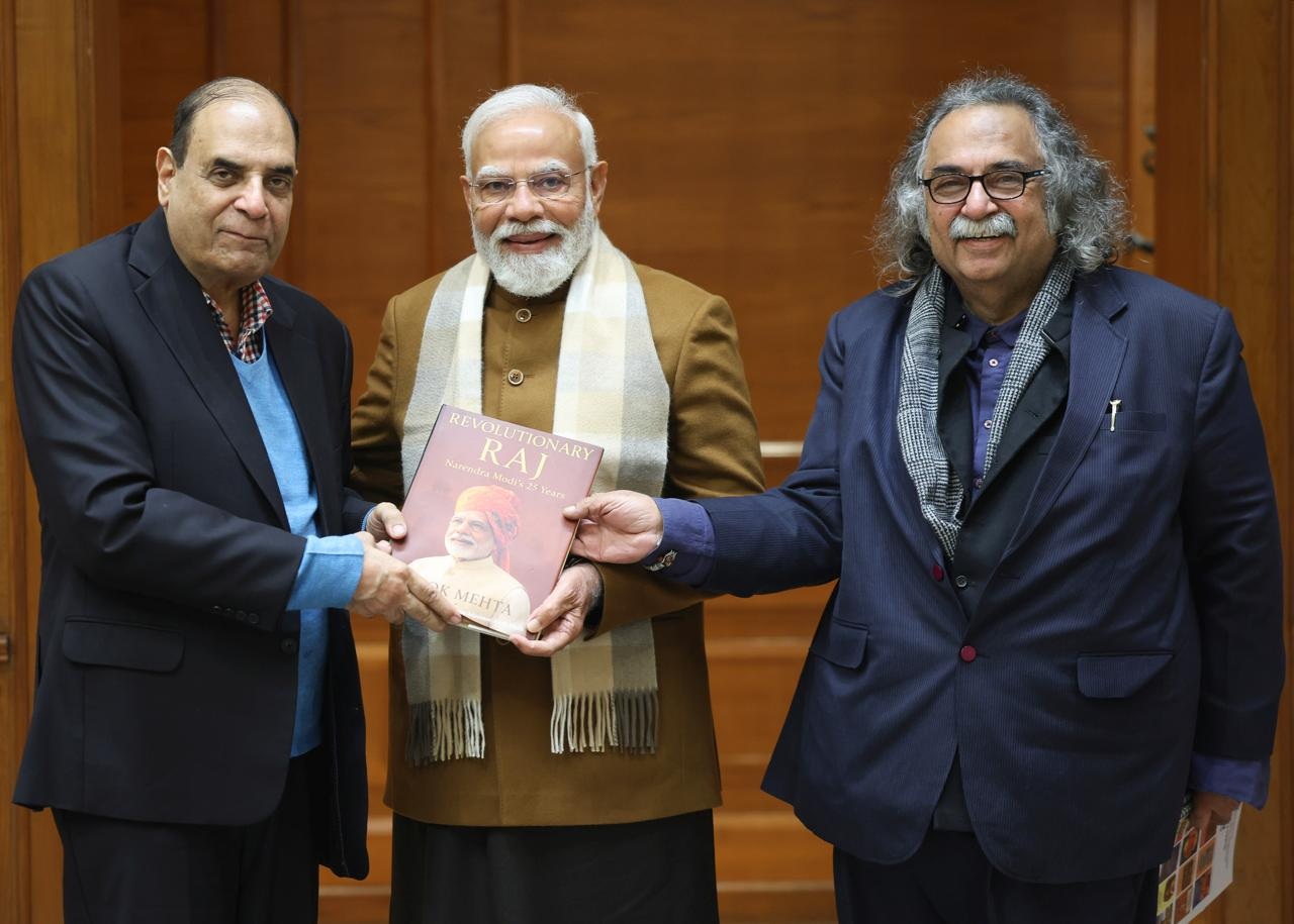 Alok Mehta Presents His Book â€œRevolutionary Raj: Narendra Modiâ€™s 25 Yearsâ€ to PM Narendra Modi